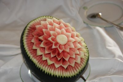 For the wedding, someone carved decorative flower on this watermelon.