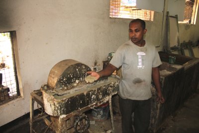 Sri Lankan man demonstrating the elephant dung paper making process.