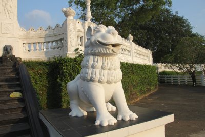 A dog statue was guarding the stupa.