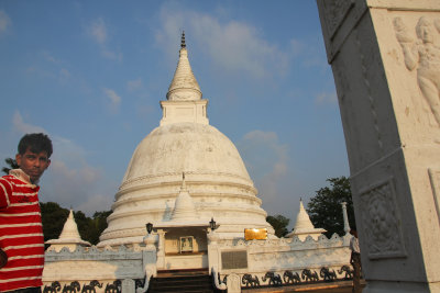 My tour guide, Kumara, standing next to the stupa.