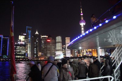 My fellow passengers getting ready to disembark from the cruise ship with a skyline view in the background.