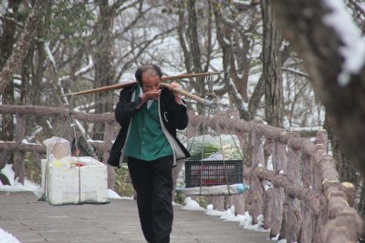 Man carrying a heavy load up Mount Huangshan.  Everything must be carried up.  The cable car is just for tourists.