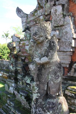 Statue at the entrance gate of  temple. Taman Ayun translates as beautiful garden.