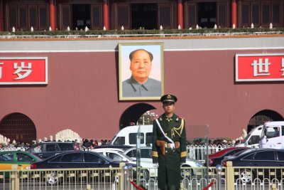 The placards next to him say: Long Live the Peoples Republic of China and Long Live the Great Unity of the Worlds Peoples.