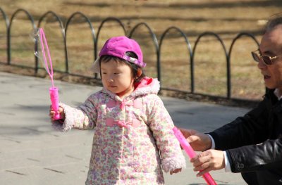 This cute Chinese girl was making bubbles at entrance of the Temple of Heaven in Beijing.