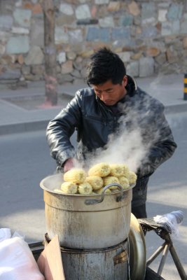 Vendor steaming ears of corn in Beijing.