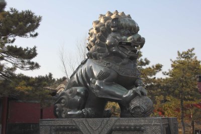 Male bronze lion guarding the Gate of Dispelling Clouds at the Summer Palace.