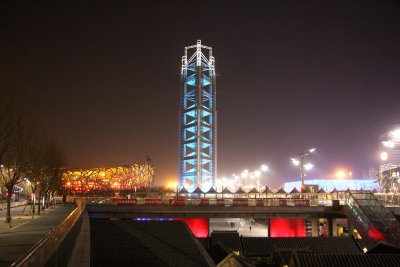 It is a three-sided tower that changes colors at night. It was built for the 2008 Olympics.