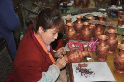 Woman putting decorations on the vases.