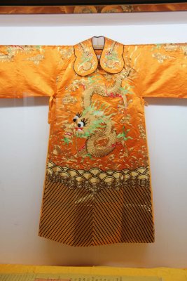 A similar yellow silk garment with a dragon.