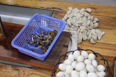 Silk cocoons and silkworms. After the worms are removed, they are eaten (not by me, thank you)!