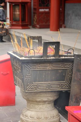Sticks protruding from another incense burner.