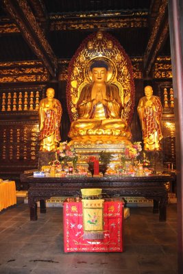 Exquisite golden Buddha statue and shrine inside the pagoda.