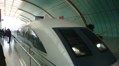 The sleek, modern train arriving in the station. During a test run in 2003, it achieved a record speed of 501 km/h (311 mph).
