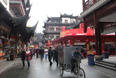 A merchant carting his wares on a tricycle in Old Shanghai.