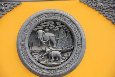 Close-up of elephant medallion on the wall.