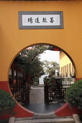 Round entrance to a pathway that goes along the western side of the temple.
