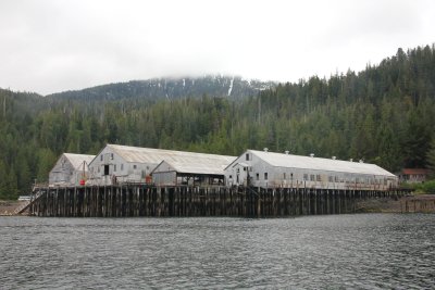 A no-longer functioning factory on the shoreline.