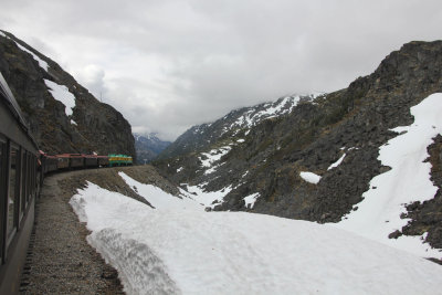 View of the front of the train and snow piled up.