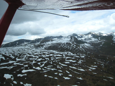 Patches of snow on the mountain below.