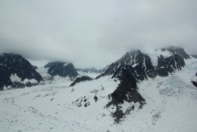 Massive glaciers wrapping around the peaks.