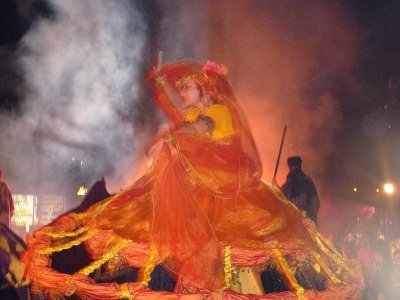 Woman shrouded in an orange lace and silk dress.