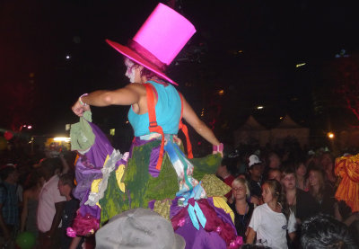 A woman on stilts wore a pink Cat in the Hat hat.