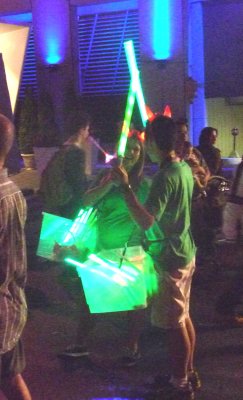 A boy and girl with green light sabers.
