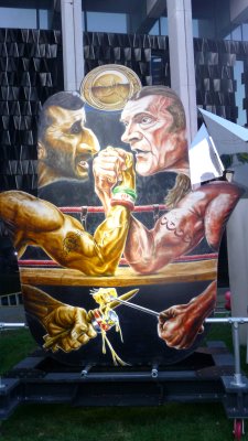 Depiction of the President of Iran, Ahmadinejad, in an arm wrestling contest.