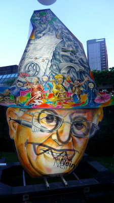 Another Dick Cheney look-alike with cartoon characters on his hat.
