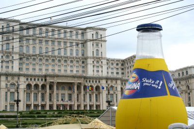 An Orangina bottle in front of the Royal Palace in anticipation of a beer and music festival.