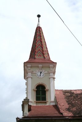 Clocktower with a beautiful tile roof.