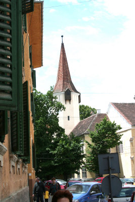 A closer view of the tower down a Sibiu street.