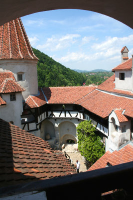 View of the courtyard, tower and rooftops of Bran Castle.