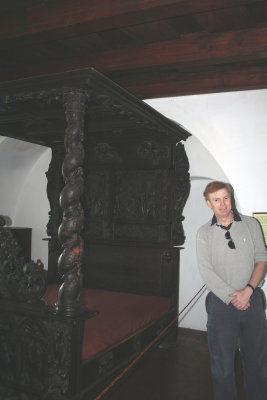 Me standing next to Queen Marie's 18th century, Baroque style, rose wood, baldaquin bed.