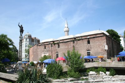 The tall sculptured minaret of the Djumaya Mosque can be seen in this photo.