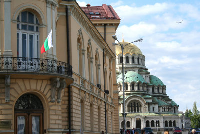 Close-up of Bulgarian Academy of Sciences Building with Alexander Nevski Cathedral in the background.