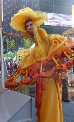 A yellow-clad woman on stilts looked like she was going to Cinderella's ball.