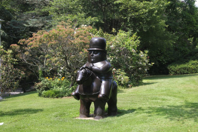 A bronze sculpture by Colombian artist Fernando Botero entitled Man on Horseback (1984).