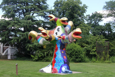 A mixed media sculptural installation by French artist Niki de Saint Phalle entitled Snake Tree (1988).