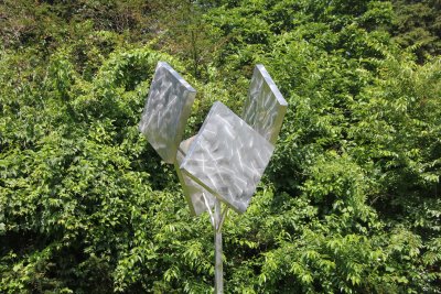 Burnished stainless steel sculpture by American sculptor George Rickey called Four Squares Excentric (The Tulip) (1989).