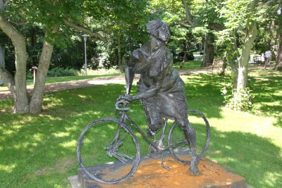 A bronze sculpture by American/Italian artist Bruno Luchese called Girl on a Bicycle (1965).