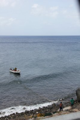 Fishermen in St. Kitts reeling in the fishing net.