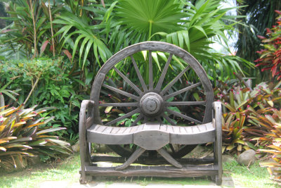 This wagon-wheel bench is an attractive addition to the garden.