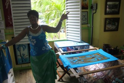 Woman demonstrating the art of making batiks using the ancient Indonesian methods of resisting dye with wax.