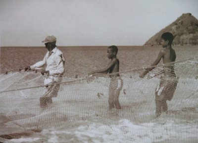 Poster in Caribelle Batik of St. Lucians pulling in a fishing net.