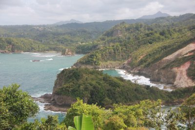 Beautiful view of the surf crashing along the rocky volcanic shoreline. Dominica is truly a tropical paradise.