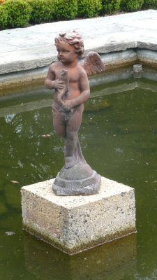 A Cupid statue in the fountain.