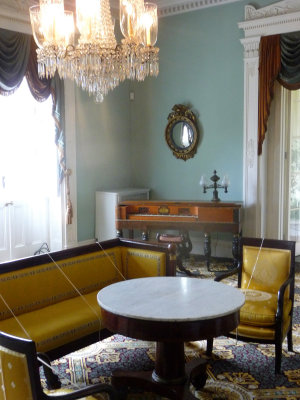 The crystal chandelier is a centerpiece of the parlor.