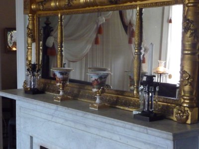 Fine ceramic vases and crystal candlesticks adorn the mantlepiece.